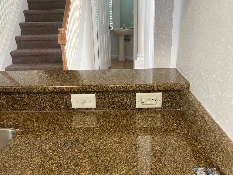 21 - Polished granite countertop with raised bar area.