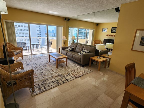 Living room furniture with a view of the balcony.