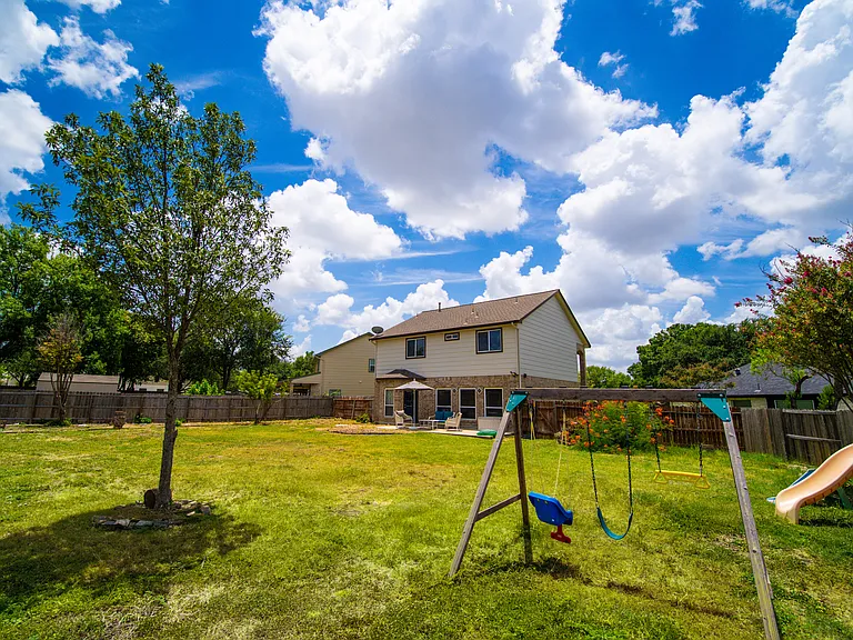 Enormous Fenced Backyard: An incredible, expansive backyard entirely enclosed by a privacy fence. With endless green space, trees, and room for outdoor play structures, it's a paradise for pets, children, and outdoor gatherings.