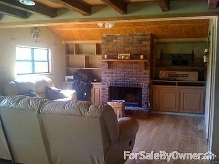 Living Room : Exposed Rafters, and Brick fireplace, Hardwood floors