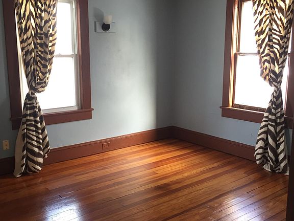dining room (or rear BR); note the new wall sconce installed. Wood floors just stained and refinished. Tin ceiling is original!
