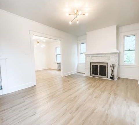 Beautiful Living room next to dining room. Real fireplace.