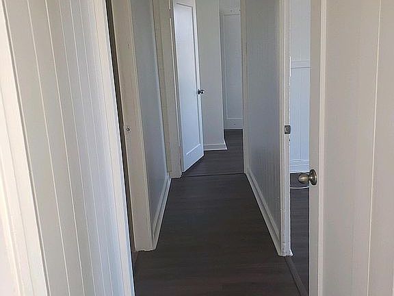 Hallway to 3 bedrooms and 1 bath. New vinyl floors and new paint.
