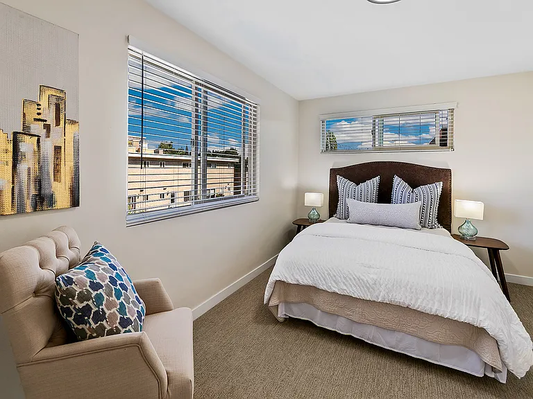 Spacious bedroom with new carpet.