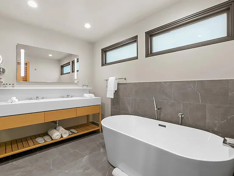 Dual sinks, balanced LED mirrored lighting and a stand alone tub with natural light