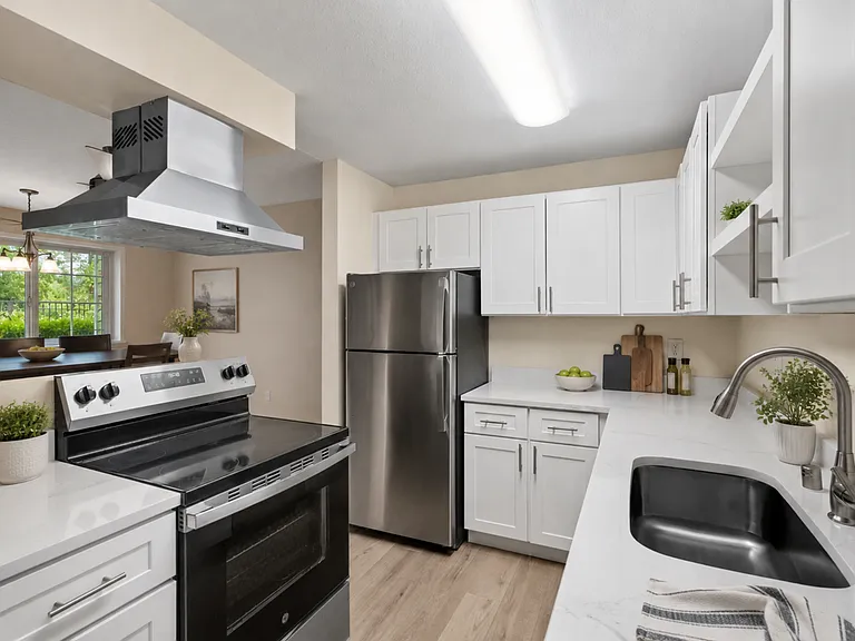 A bright, updated kitchen with modern finishes, generous cabinet storage, stainless steel appliances, and an open view into the dining area. A bright, updated kitchen with modern finishes, generous cabinet storage, stainless steel appliances, and an open