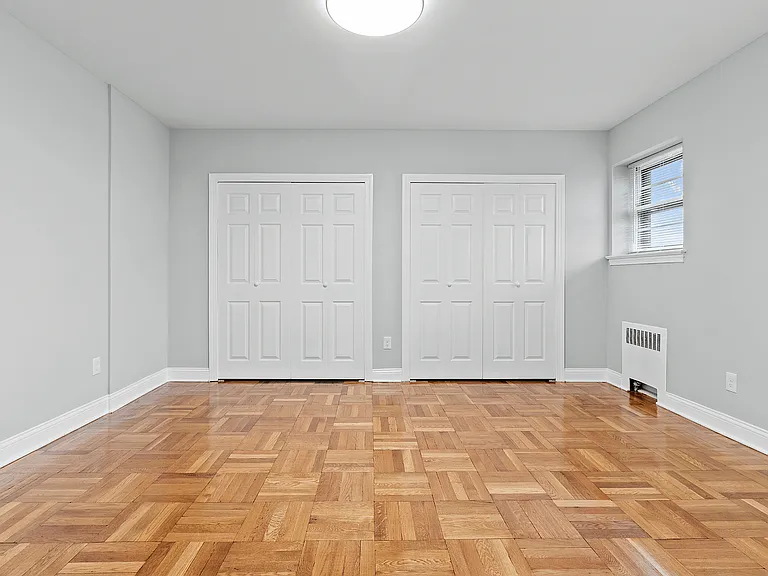 Experience the elegance of this spacious bedroom featuring stunning wood floors and abundant closet space.