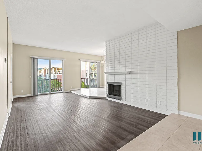 Living Room with Electric Fireplace, Vinyl Flooring, and Balcony