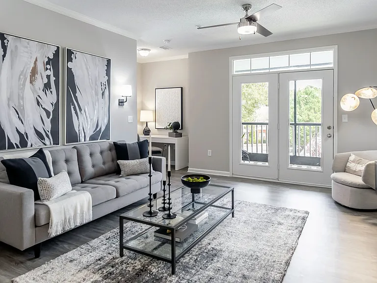 Embrace the best of both worlds in our spacious living room with access to a serene, screened patio. (In select units)