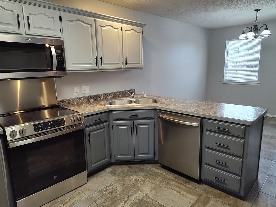 repainted cabinets, all new SS appliances. Tile floor, formica countertop. New handles, hinges.
