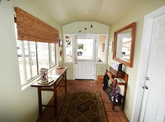 Inviting Entry with Dutch front door and side panel windows. Side entrance to garage.