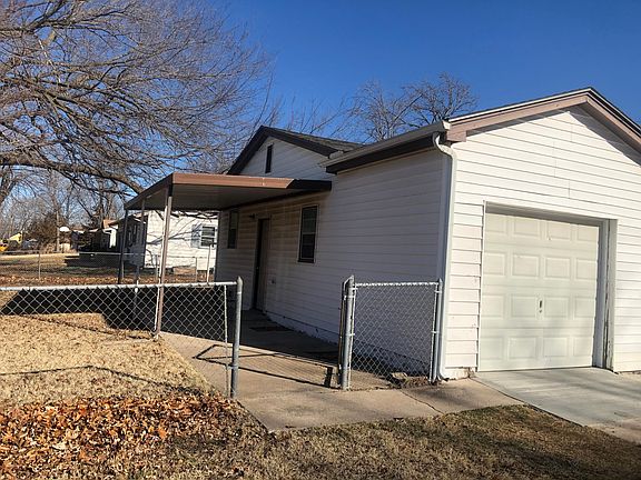 Side entrance to garage. Gated, large yard.