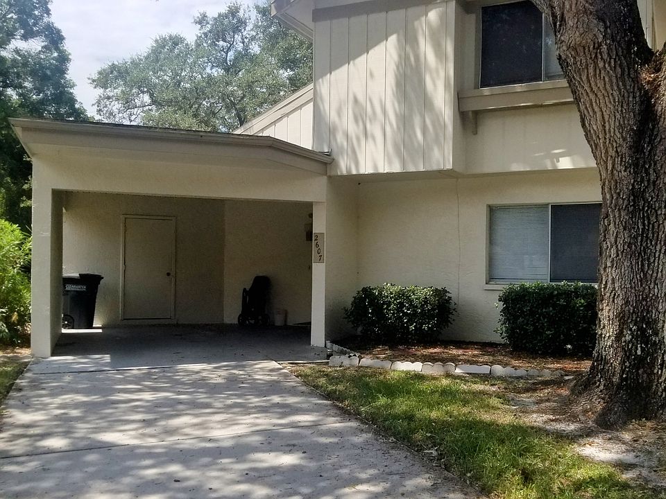 2 story townhome with attached carport, storage closet and private driveway