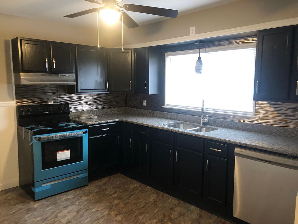 Granite and stainless steel kitchen. New flooring, backsplashes and hardware.