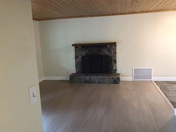 Living room with gas fireplace and brand new flooring