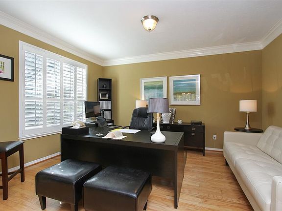 The formal living room (or study) is approx. 15x12 and has wood flooring, crown molding and shutters framing the front view.