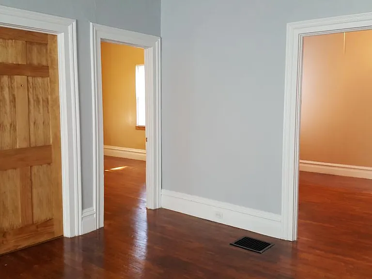 Living Room facing the front entrance and 2 large bedrooms