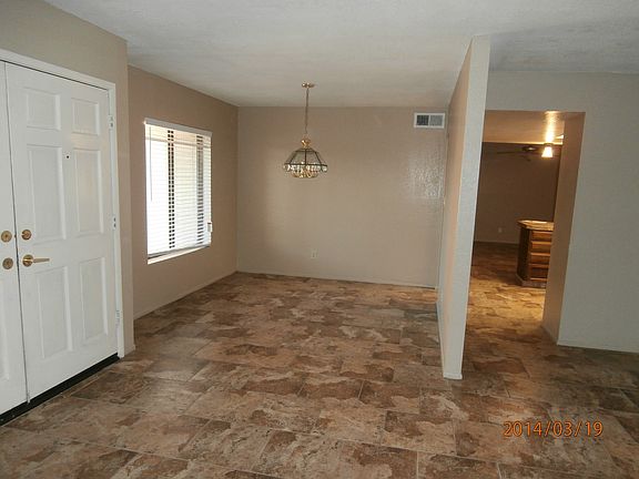 Entry door foreground, formal dining room. On right looking into kitchen & family room.