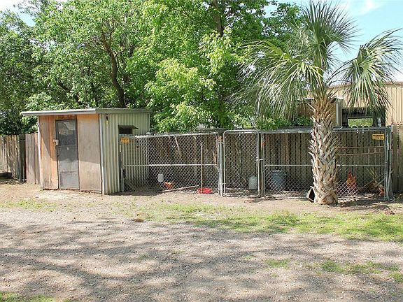Head down the long secondary drive and notice the large chicken coupe on the side if you choose to raise chickens. There are no restrictions on this property.