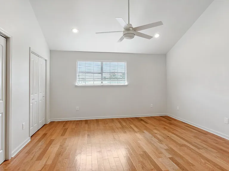 Master Bedroom with high ceilings, two his and hers closets, brand new touch blinds, brand new remote activated ceiling fan and a linen closet.