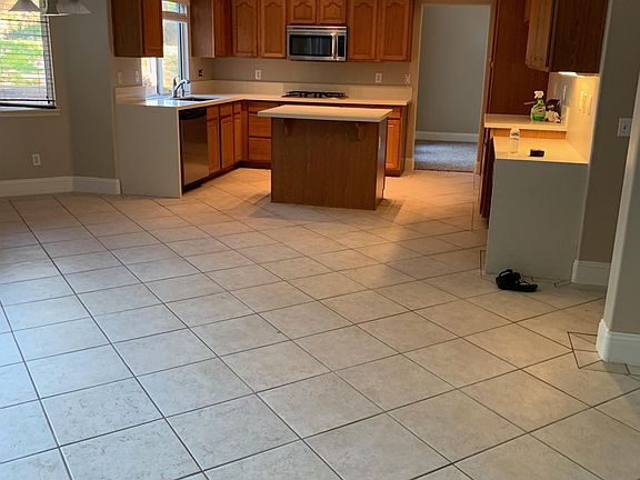 Bright light kitchen with desk area. New quartz counters and stainless appliances. Beautiful views of your huge, private backyard.