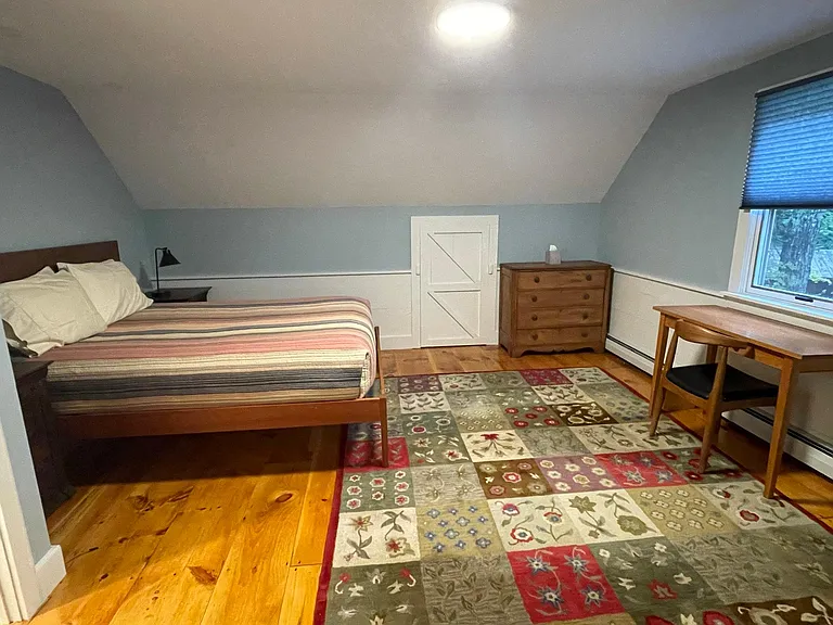 Queen bedroom has sitting area and desk