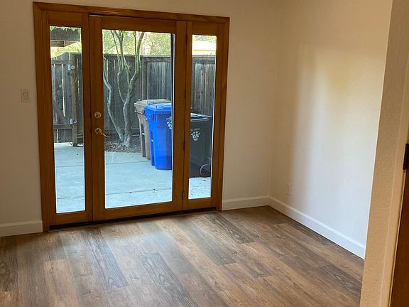 The dining room with a door to one of the two enclosed patios.