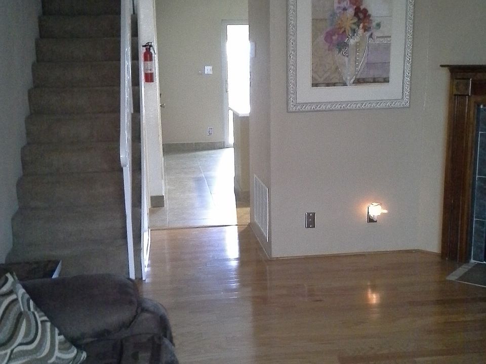 Living room with wood floors looking to back garden patio an
