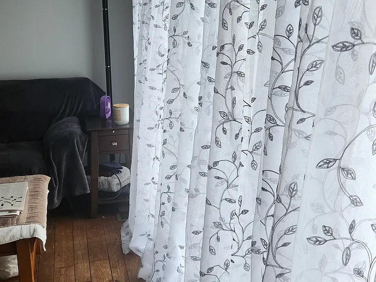 Shared livingroom with floor to ceiling one way curtains - seeing out only