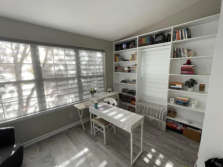 Dedicated built-in office ideal for remote professionals, creatives, or executives seeking a quiet and functional work-from-home environment with custom shelving and natural light.