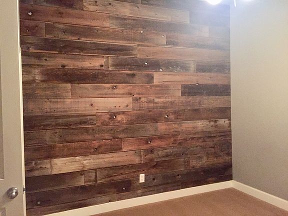 Bedroom w/ wood wall