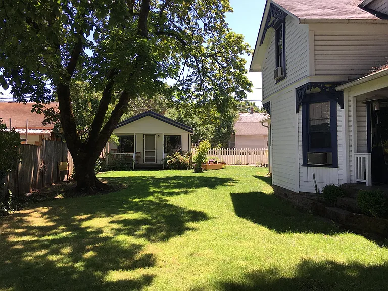 From the front of the property/north corner facing the cottage that houses our dear friend/acting on-site assistant and nice sized side yard