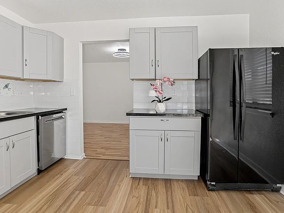 Kitchen with new wood cabinetry, new stainless steel dishwasher, granite counter tops