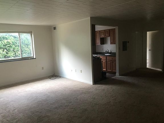 Looking from entry into living room / kitchen / toward bathroom and bedroom.