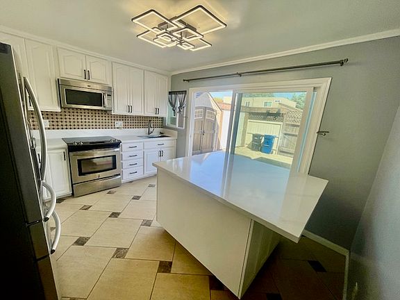 Kitchen island has storage and can be moved