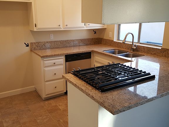 Kitchen with new stove, dishwasher and granite