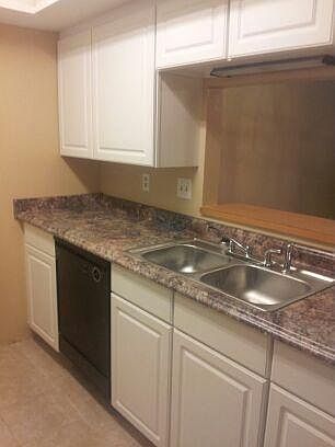 Kitchen has microwave, side by side fridge with ice maker,