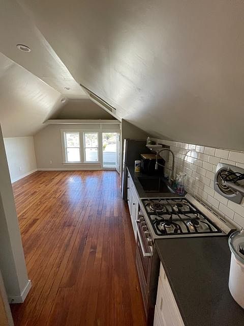 Kitchen has stainless steel gas range, solid surface counters and new cabinets.