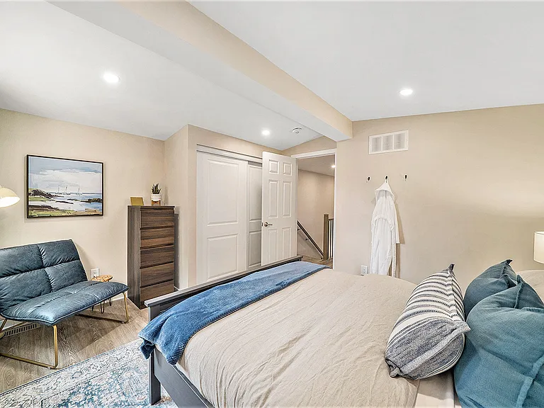 Comfortable bedroom with Queen bed, stylish accents and storage.