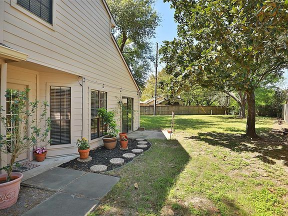 Front Entrance with gorgeous mature trees and plenty of room for any outdoor activities.