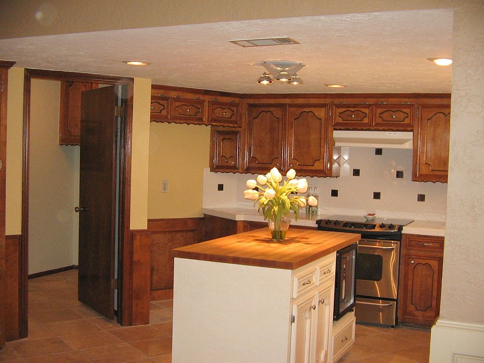 Large island kitchen with tile counters & backsplash.
