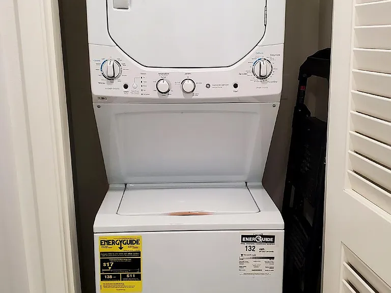 Stack washer and dryer unit in the kitchen closet