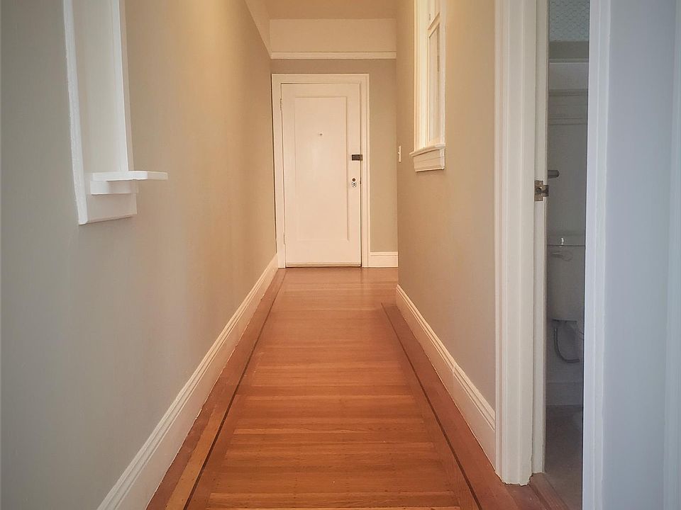 Hallway looking toward front door. Bathroom first door on right, kitchen next on the right.