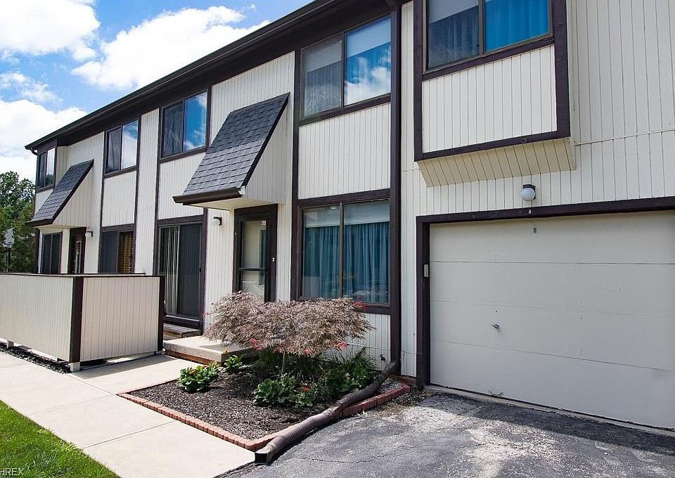 Front Elevation with private patio and 1 car Garage.