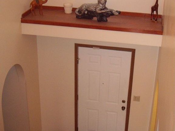 2 story foyer with plant shelves and arched openings