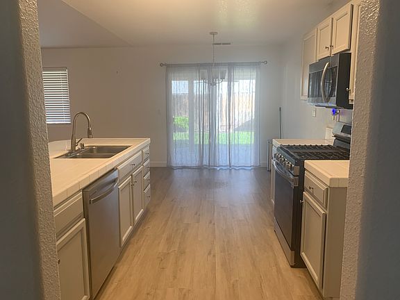 Kitchen with breakfast nook in front of the sliding door to backyard.