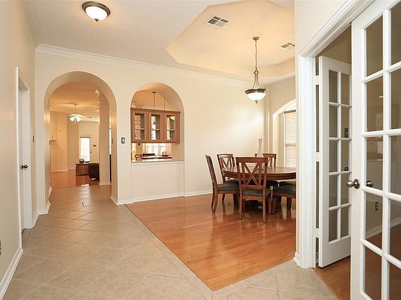 Inviting you through the front door to tile and wood floors, arches and nicely appointed architectural details.