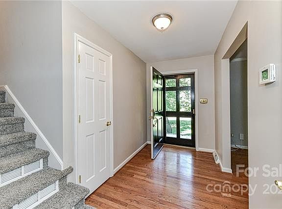 Entry way with beautiful window paned door. Coat closet and new thermostat.