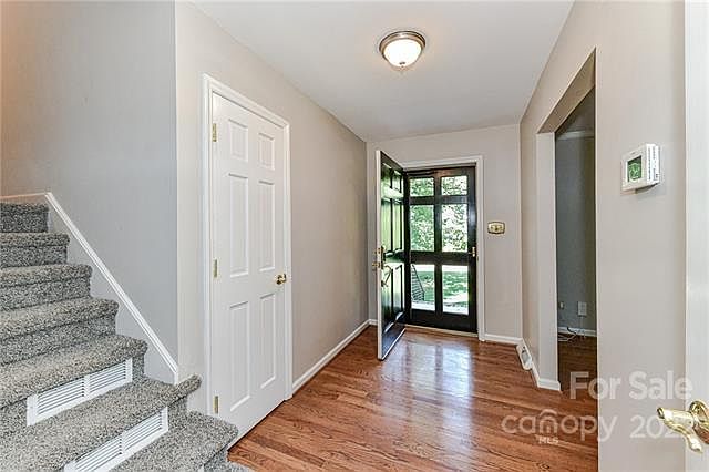 Entry way with beautiful window paned door. Coat closet and new thermostat.
