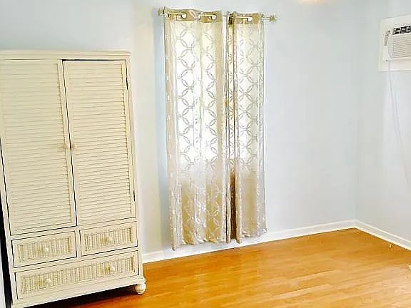 Well lit bedroom with nice floors. (Wardrobe not included)